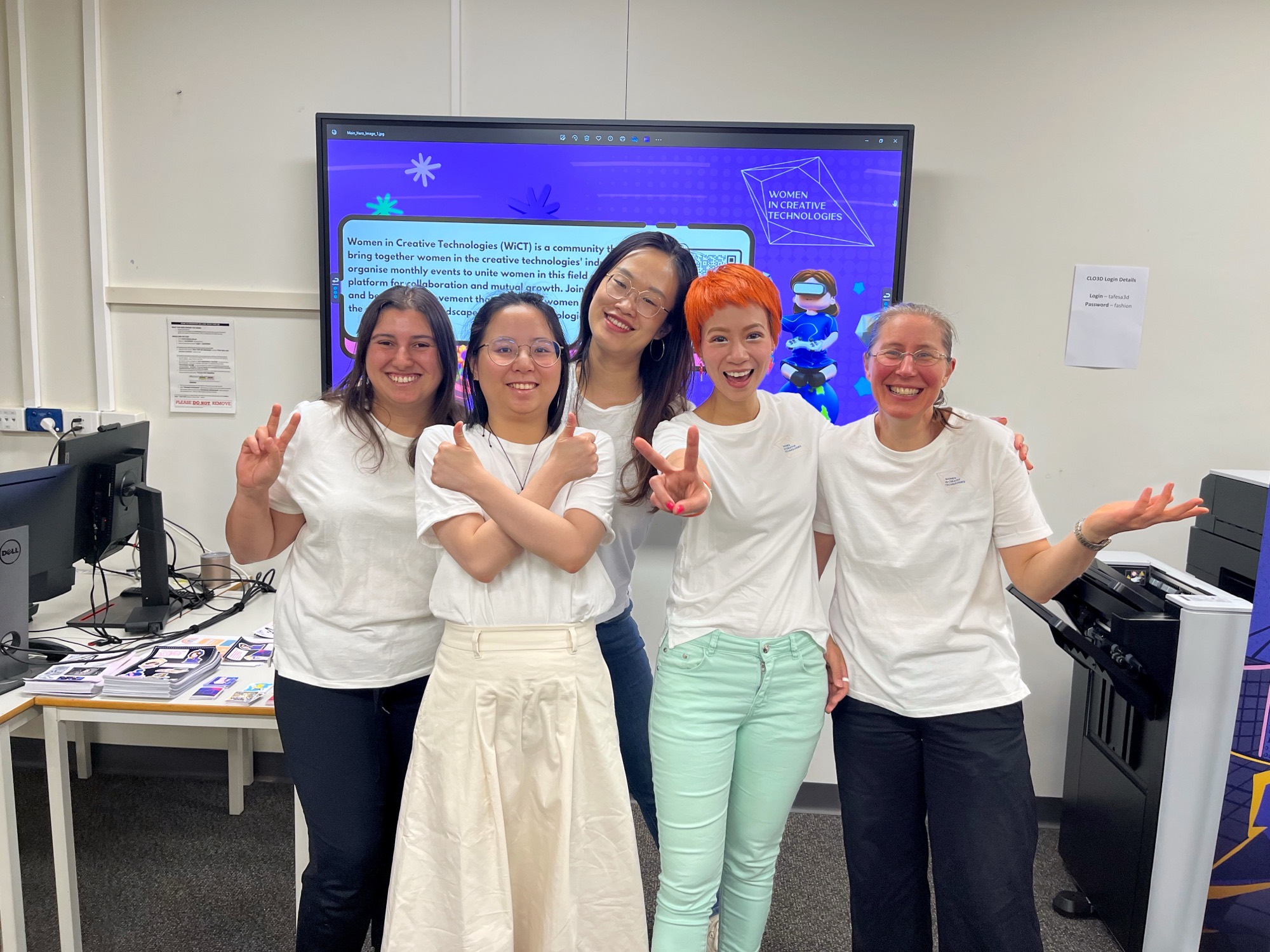 The WiCT team in matching WiCT t-shirts, standing in front of a screen showing the WiCT mission statement.